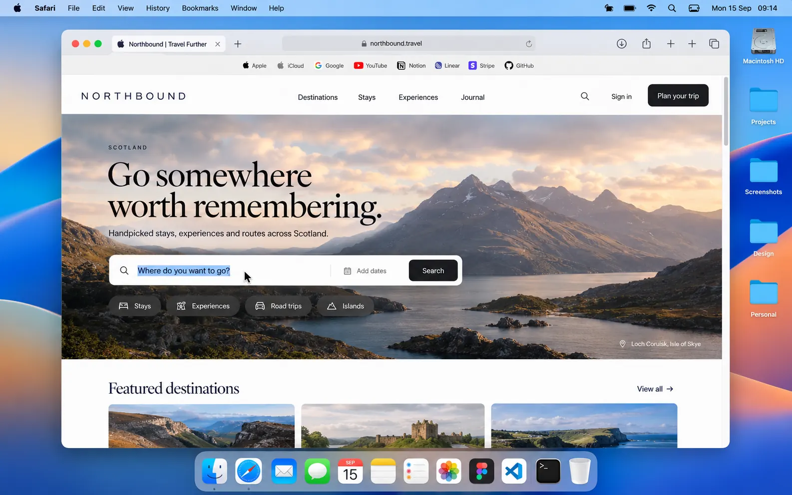 A Mac showing Safari, being controlled from the iPad and iPhone in front of it